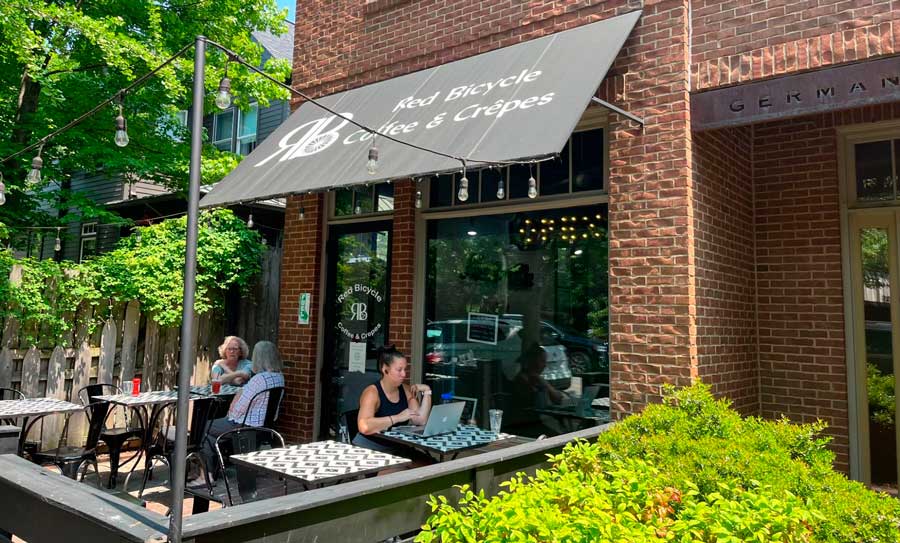 People from the outdoor dining area of Red Bicycle Coffee & Crepes