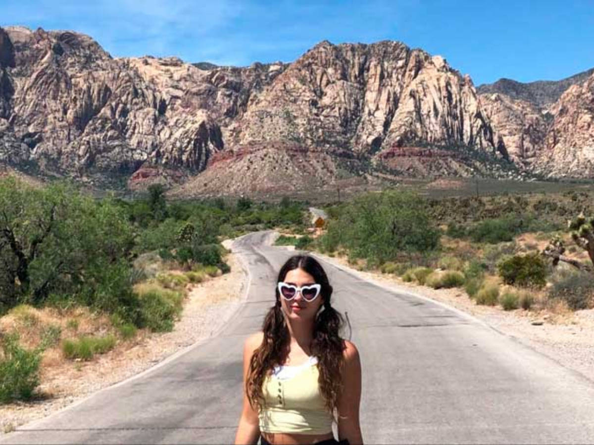 The author, Isabelle Pavese smiling for a photo in Red Rock Canyon National Conservation Area in Las Vegas