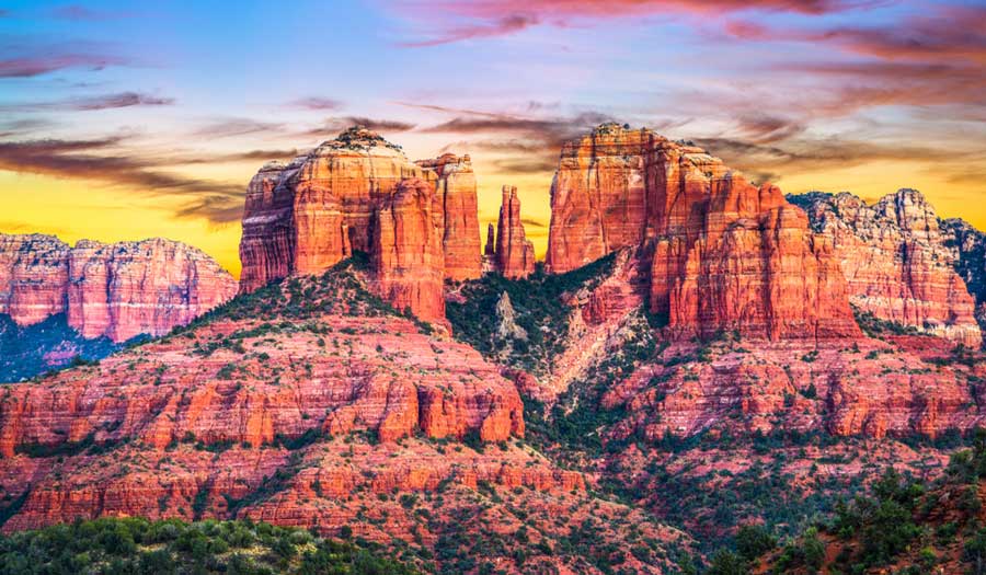 Red rocks and a colorful sky over it in Sedona, Arizona