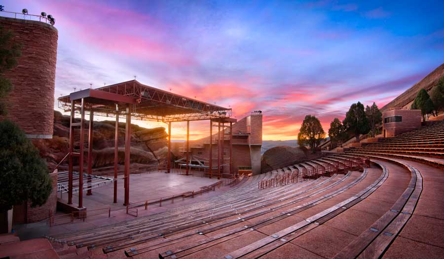 The Red Rocks Amphitheatre under the colorful sky during sunset