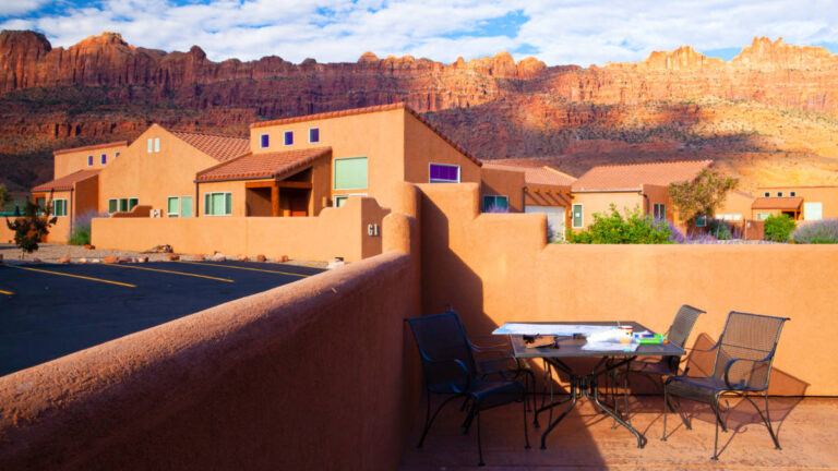 View of the sunrise over a red rock resort in Moab just outside of Arches National Park