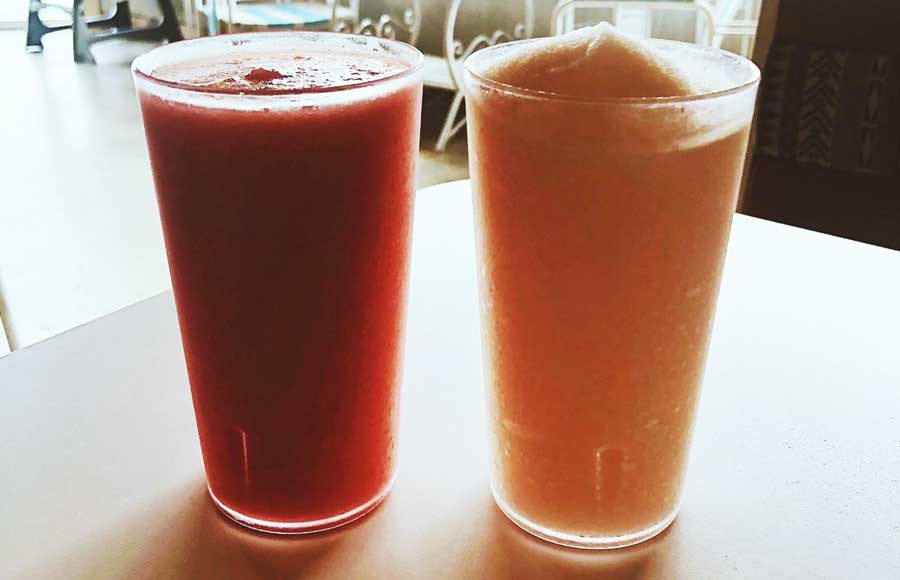 Two glasses of frozen margarita on a table in Redheaded Stranger