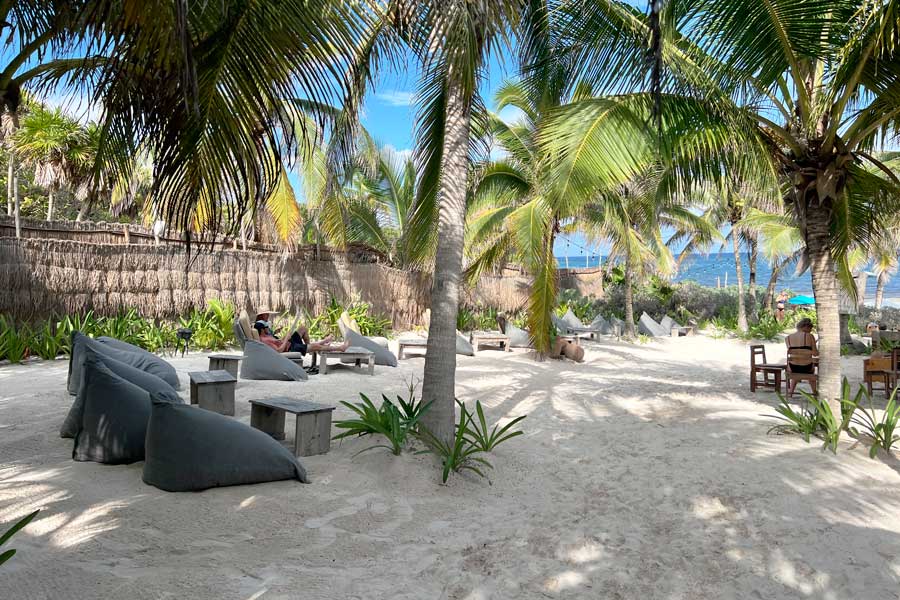People relaxing in Cinco Tulum with the beach view