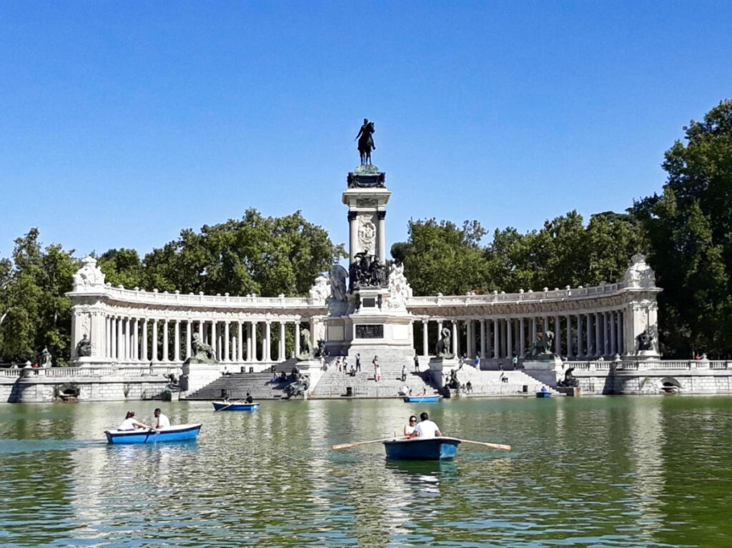 View of the people riding the rental boats on the Great Pond at Madrid’s El Retiro Park