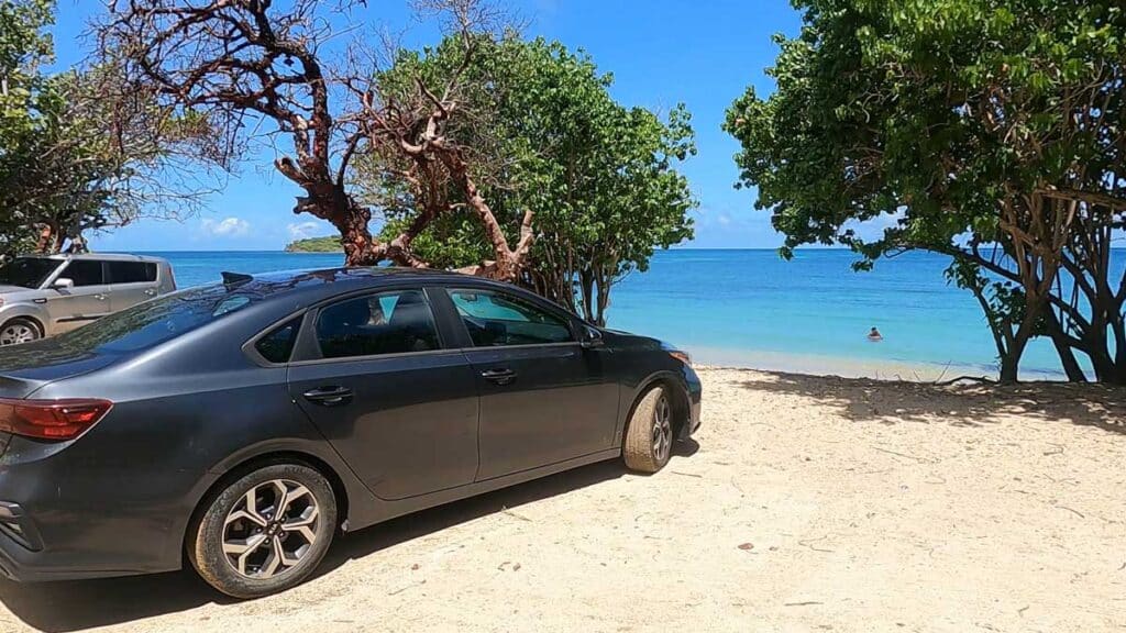 A rental car parked in front of a beach in St. Croix