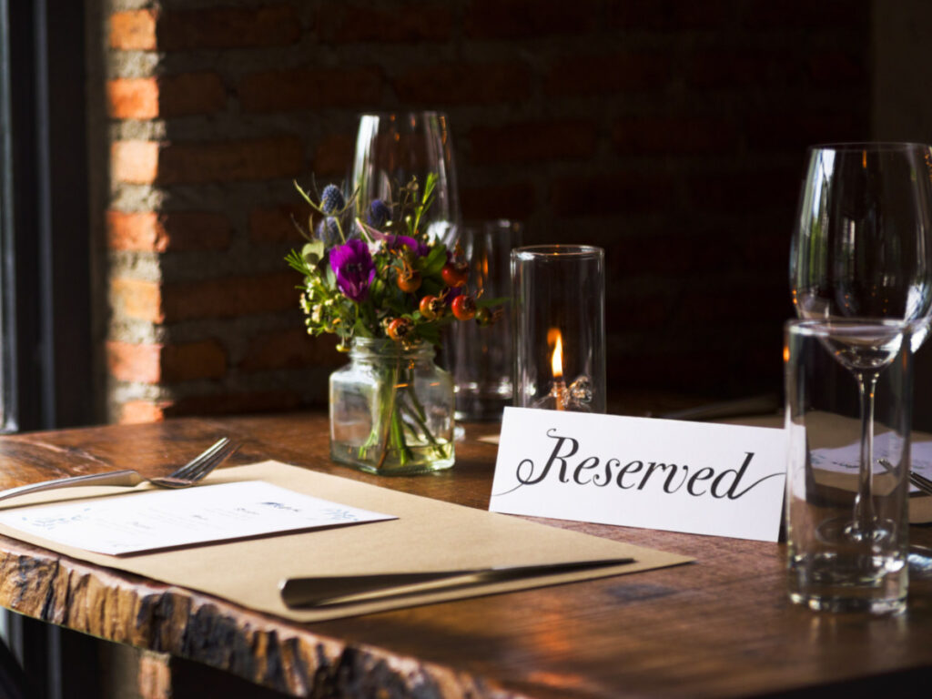 A restaurant table with reserved sign on it
