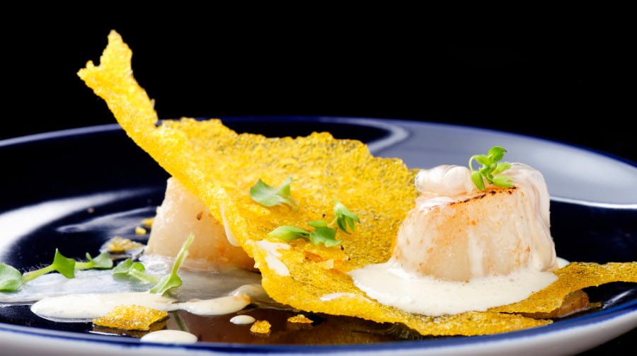 A gourmet cuisine of scallop in a piece of corn crisps served in Restaurant Guy Savoy