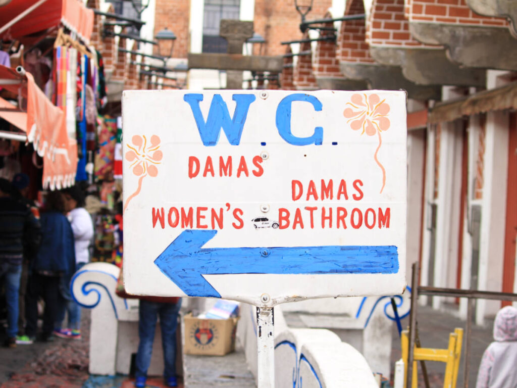 Closeup look of the public restroom sign from the street