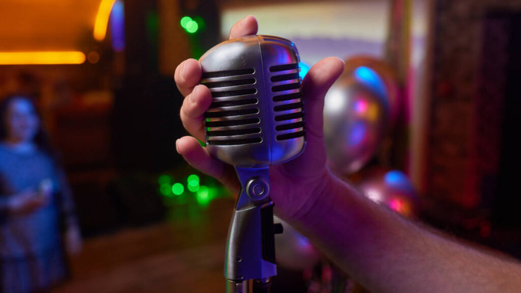 A hand holding the retro microphone
