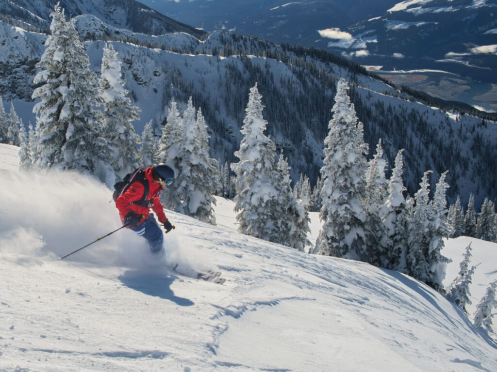 A person skiing down a snowy slope in Revelstoke. Enjoying the thrill of winter sports