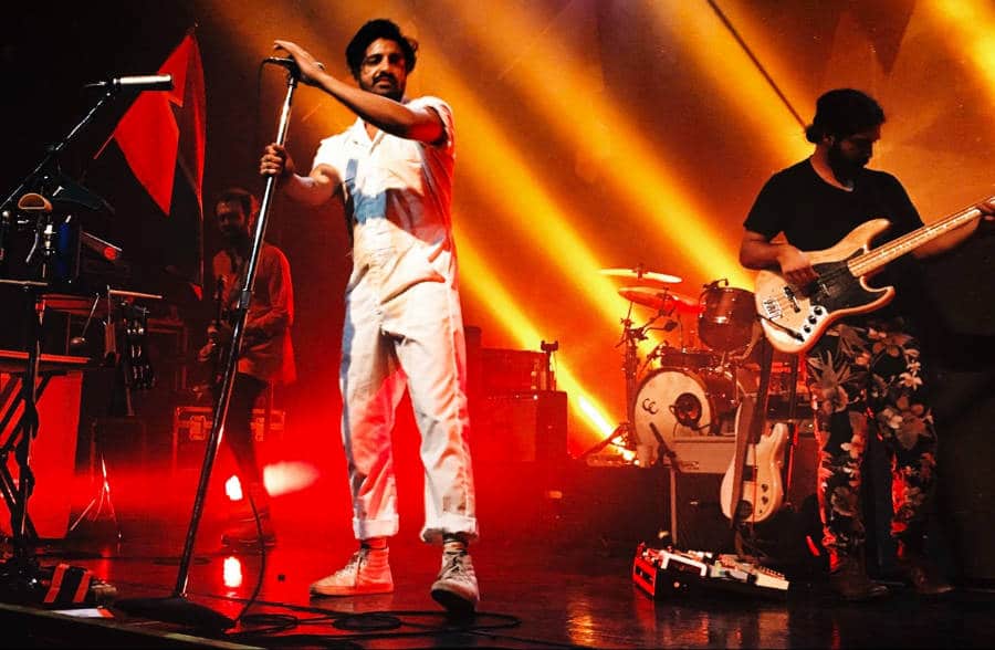 A man performing with the band on the stage of Rialto Theatre in Tucson