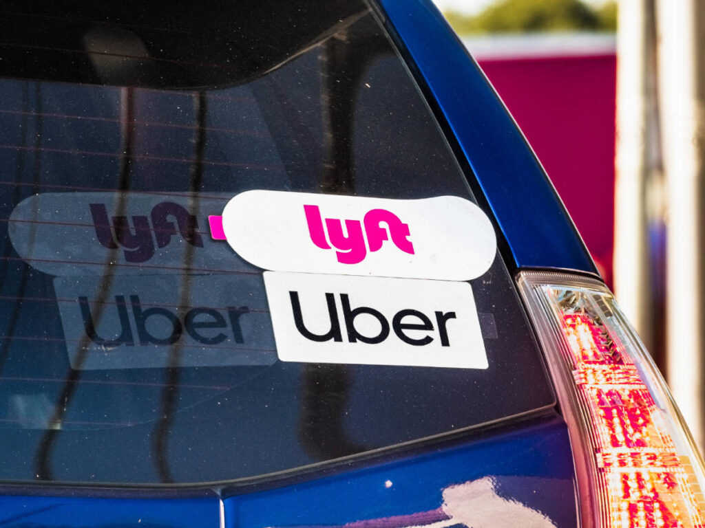 Logo of Lyft and Uber on a car in Jersey City