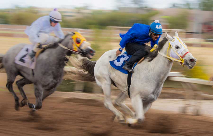 A horse race happening at the Rillito Park Race Track