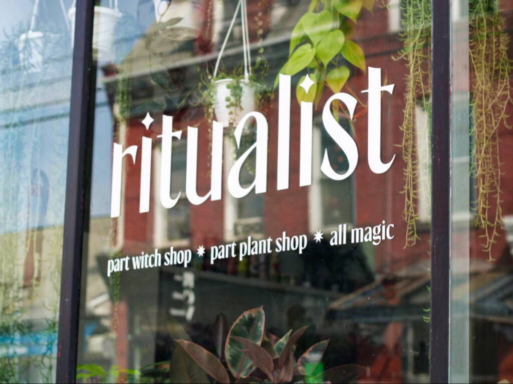 The sign of Ritualist Boutique on the glass window