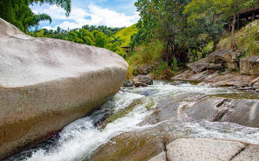 View or rocks with carved drawing in a river in Jayuya