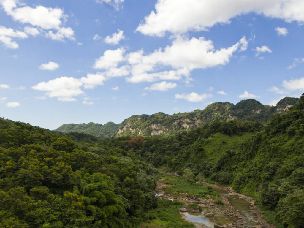 Aerial view of the limestone mountains and the river surrounded by greenery