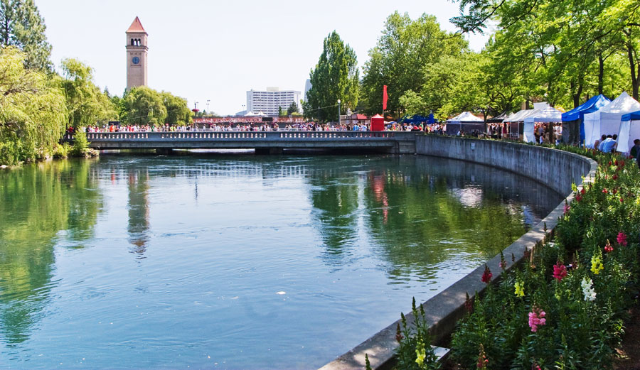 View of the Riverfront Park with the clock tower and people roaming around