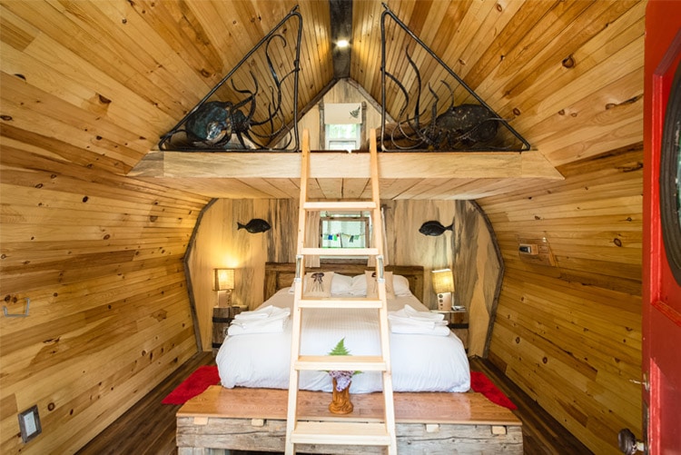 view of cabin with two beds and lamps