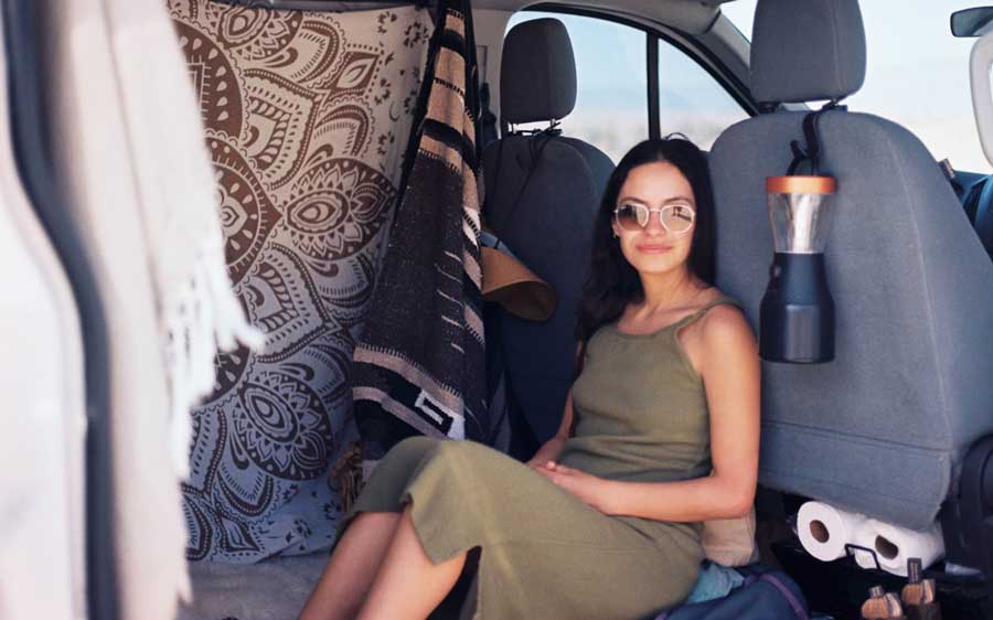 The author sitting inside her road trip vehicle