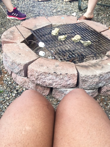 View of roasting oysters and marshmallows on a fire pit