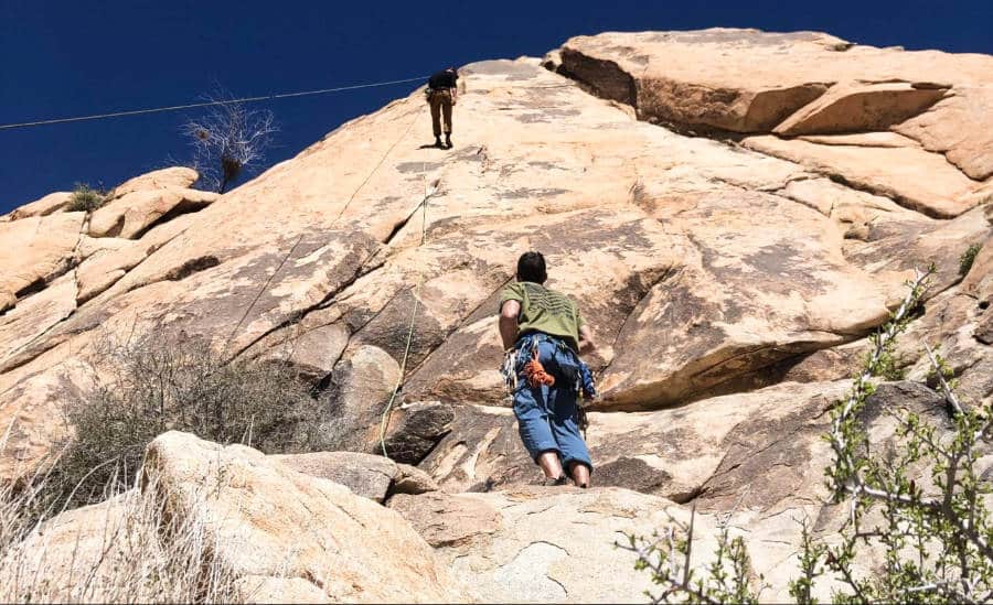 Two people rock climbing in Moab, Utah