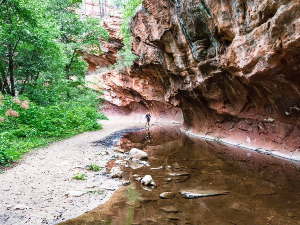 A man posing near the rock formation in Oak Creek Canyon