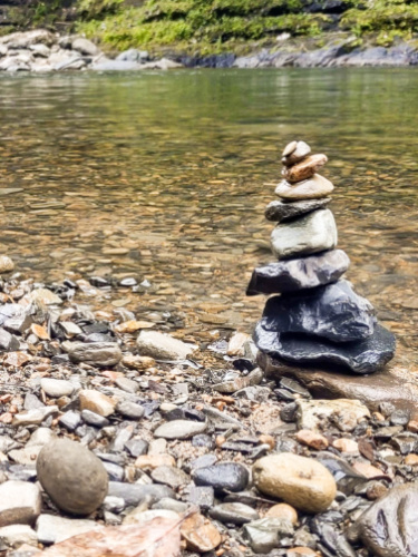 A rock tower nearby the water in Puente Roto in El Yunque