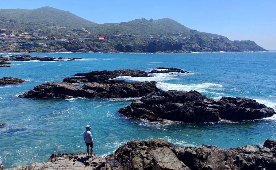View of a man looking at the rocky coastline in Ensenada