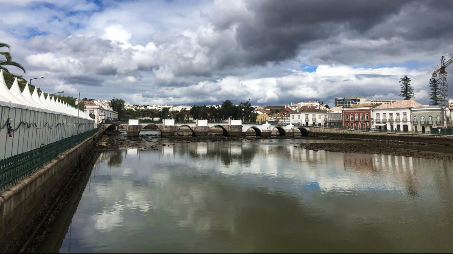 View of the Roman Bridge and the seven arches over the Gilão River on a cloudy day