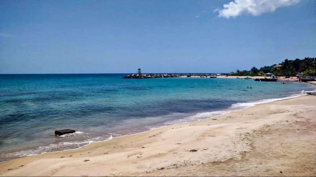 Panoramic view of the calm and clear water of Rompeolas Beach on a sunny day