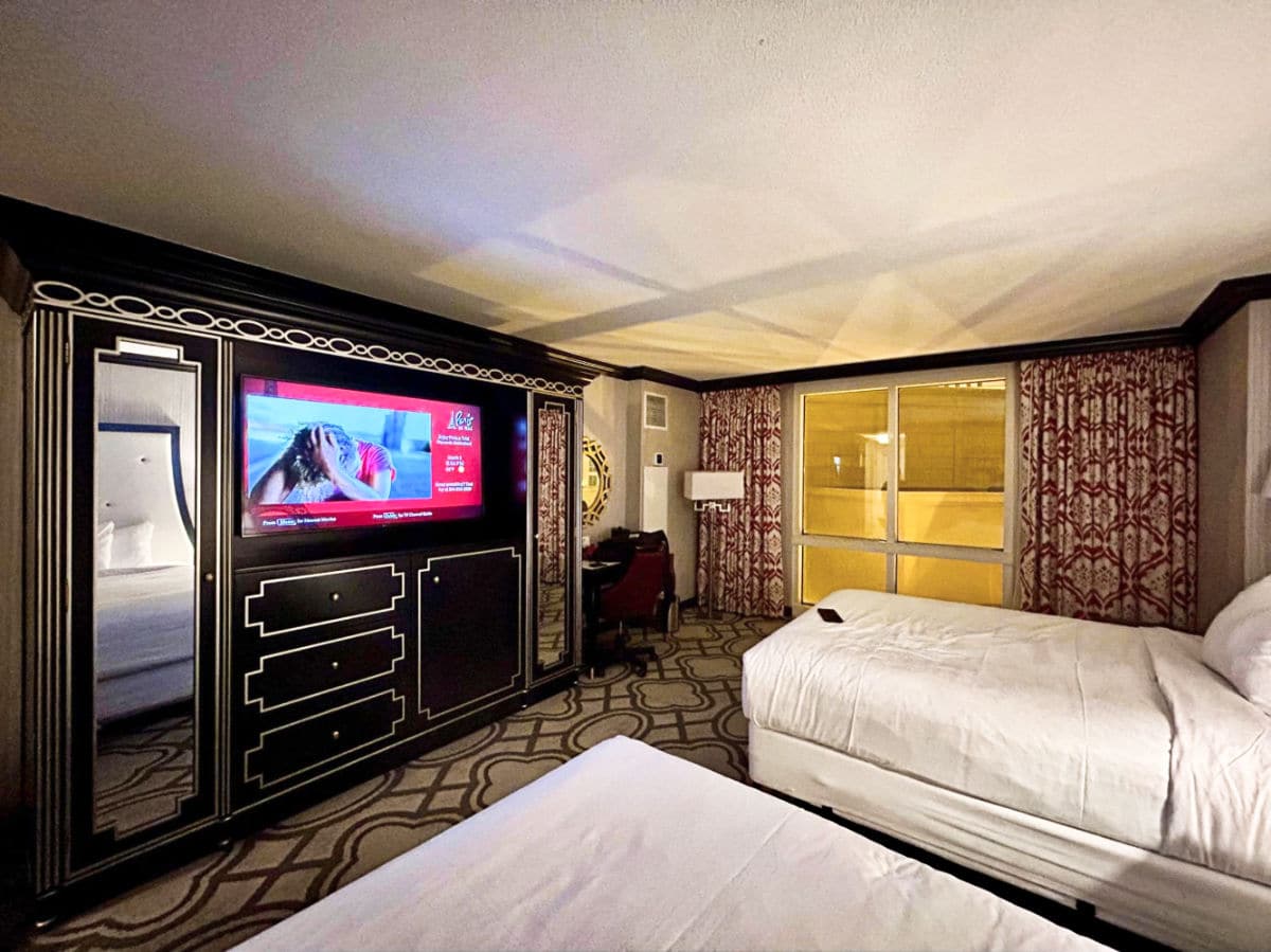 View of the two beds in front of the TV inside the room in Paris Las Vegas Hotel & Casino
