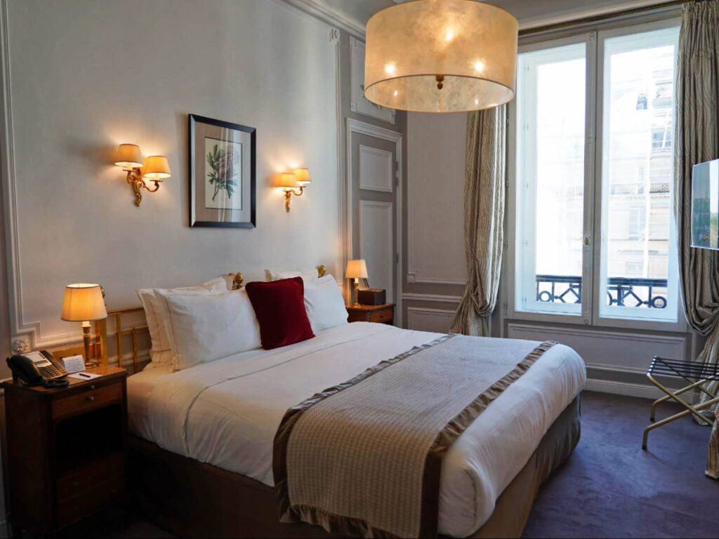 View of the bedroom at the Hotel Regina Louvre