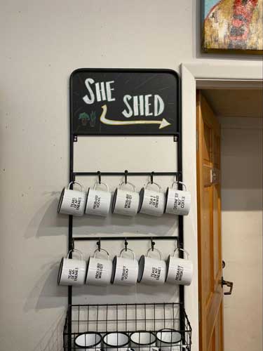 Mugs hanging on a wall inside the Roots ABQ