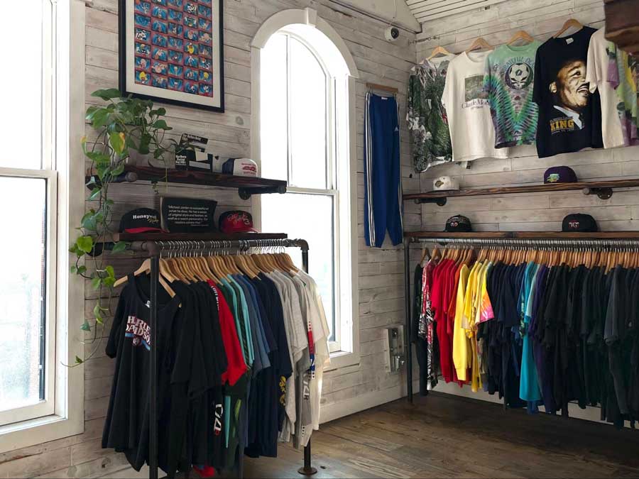 Shirts and caps displayed inside the Round Two Store