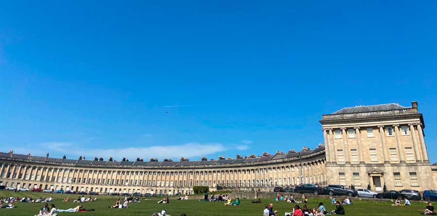 People enjoying their day on the greenfield of Royal Crescent