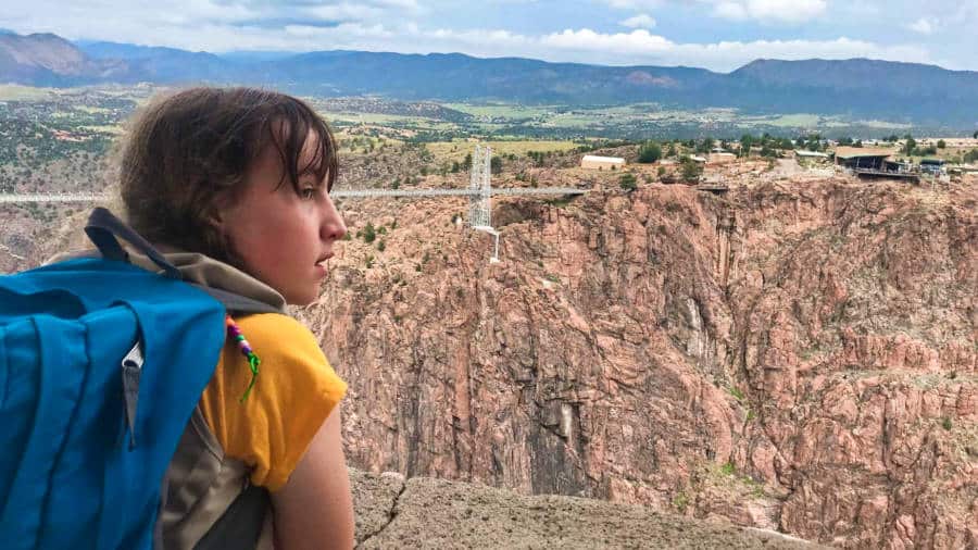 A girl looking at the scenic views in Royal Gorge Bridge & Park from the viewpoint
