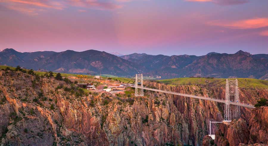 The Royal Gorge Bridge from afar under the colorful sky