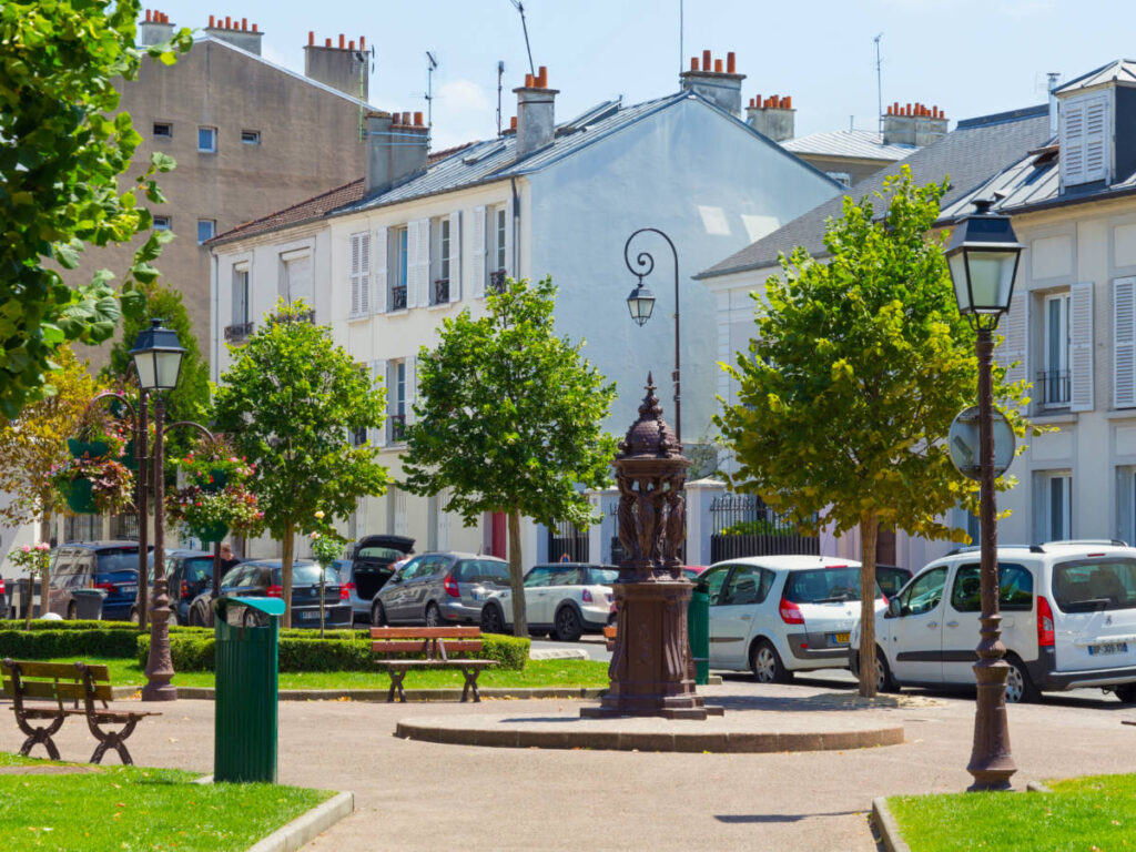 Small town resting area with benches and sculptures on the Rue Gabrielle street