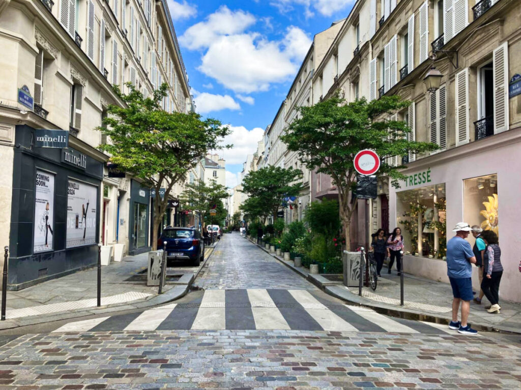 View of the famous pedestrian lane and shops around the Rue de Rosiers street