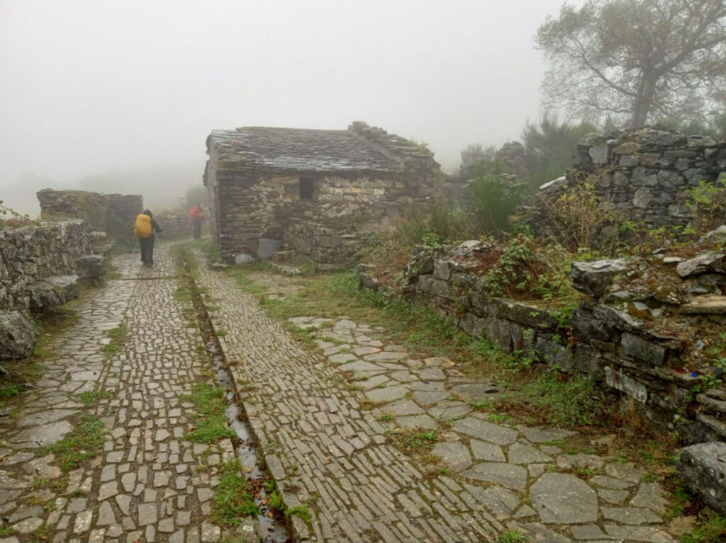 Hikers along Ruins between A Fonsagrada and O Cadavo on a rainy day