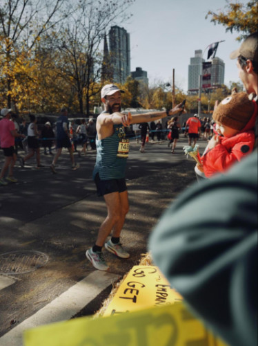 Runner surprised as he sees his friends at the NYC Marathon