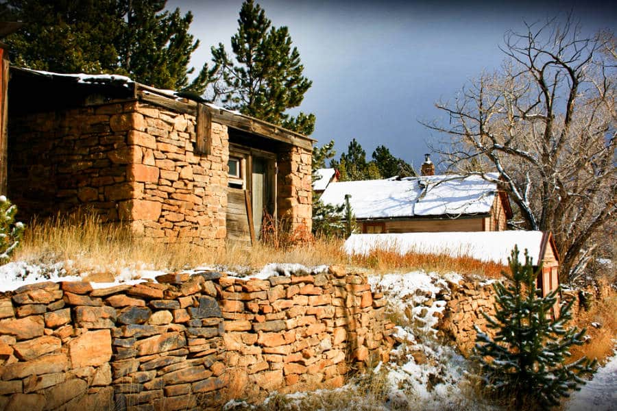 Snow-covered buildings made with brick on a gloomy day in Russell Gulch during winter