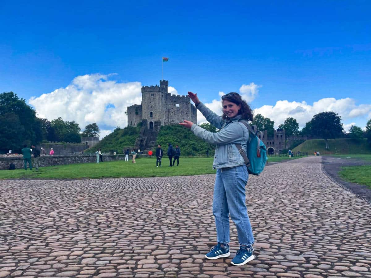 The author Ruthie Walters, "holding" the Norman Keep, Cardiff Castle in the background