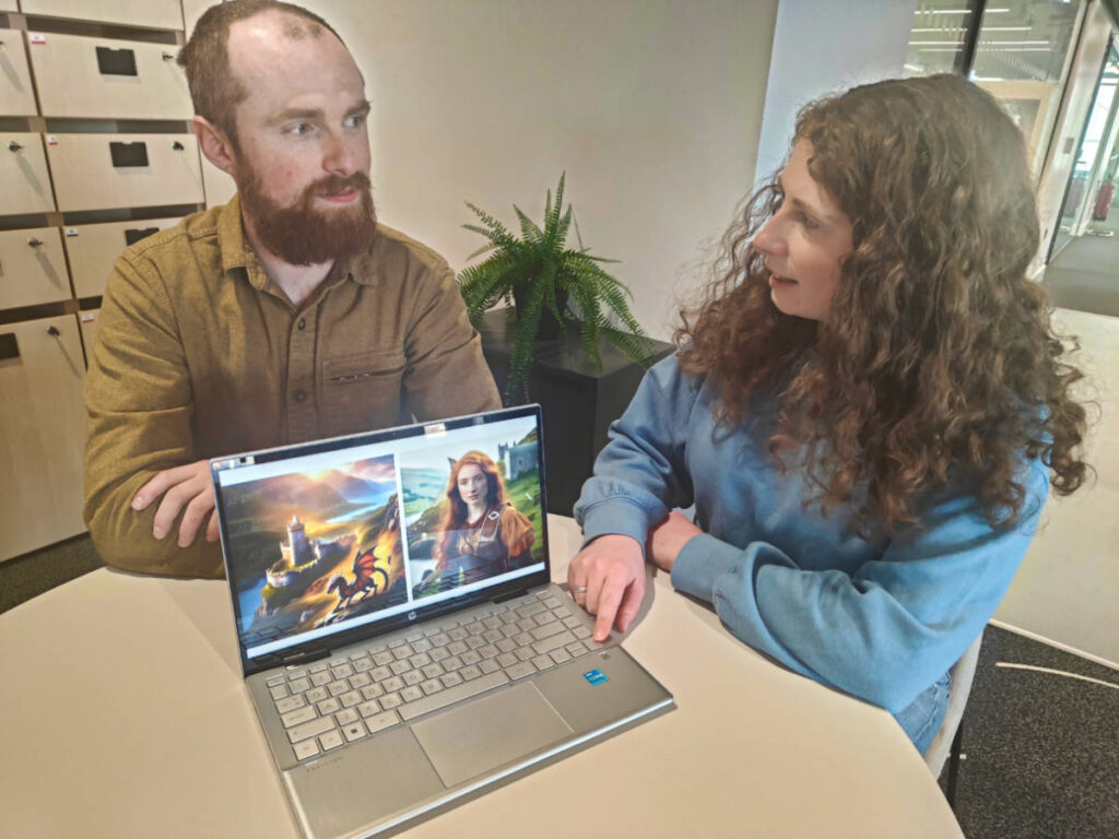 The author Ruthie and Morgan showing the AI generated images of a dragon and a red head woman on the laptop