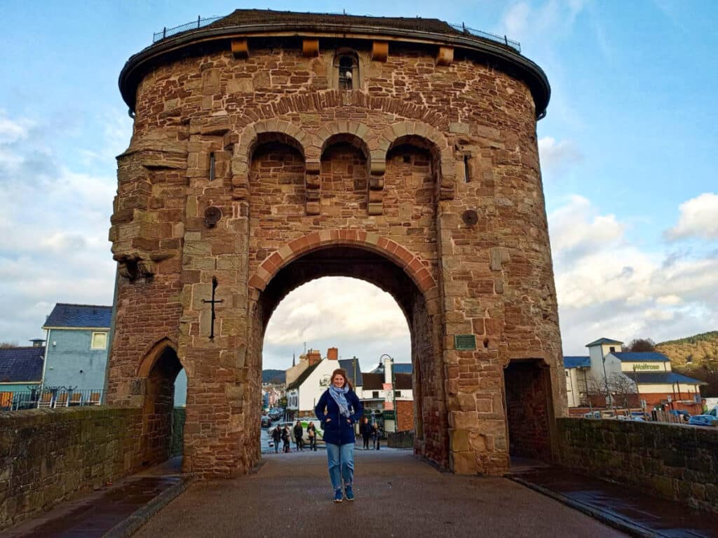The author Ruthie Walters, posing for a photo at the Monnow Bridge