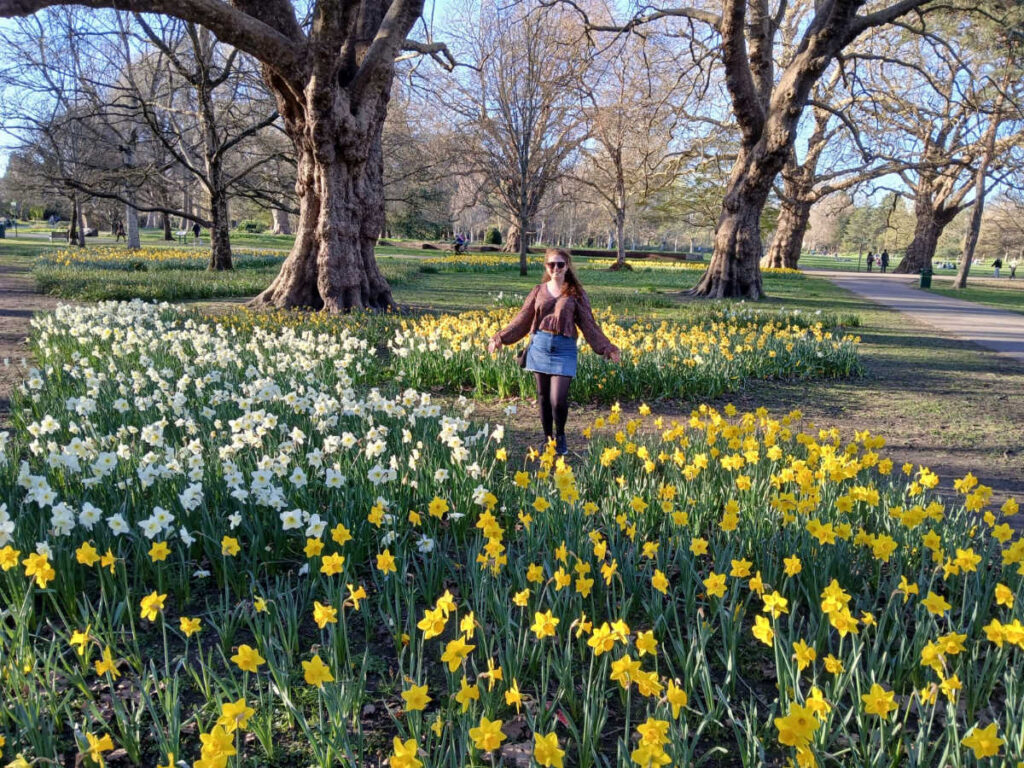 The author Ruthie posing for a photo with the blooming flowers at the Bute Park in spring