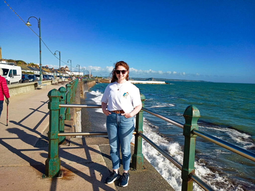 The author Ruthie posing for a photo at the Penzance Promenade