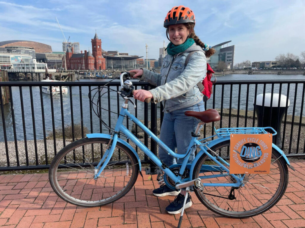 The author Ruthie holding a bicycle from Ding Cardiff Cycle Tours