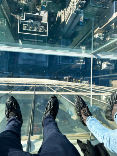 View of the shoes covered with plastics on the glass floor of SUMMIT One Vanderbilt