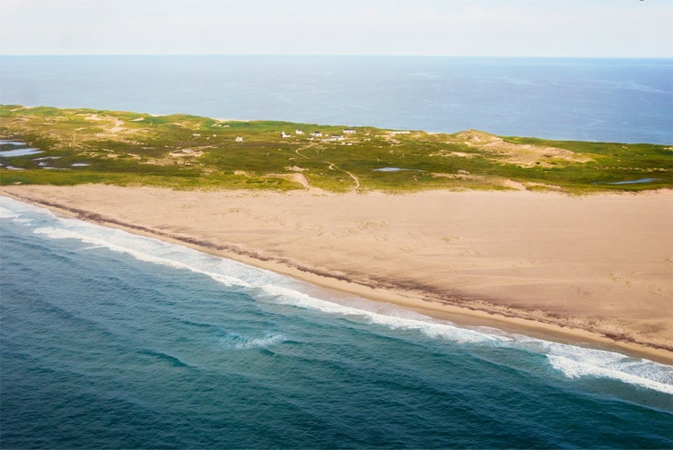 View of the sand and landscape on an island surrounded by water